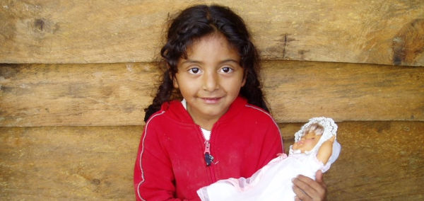 Little Coralia holding a doll