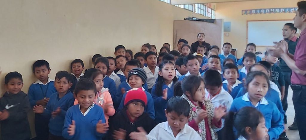 Axel nd classmates singing in school devotional
